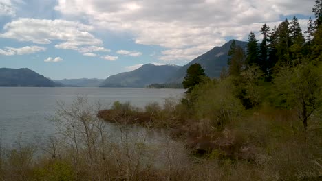 Drone-shot-of-lake-with-mountains-in-background