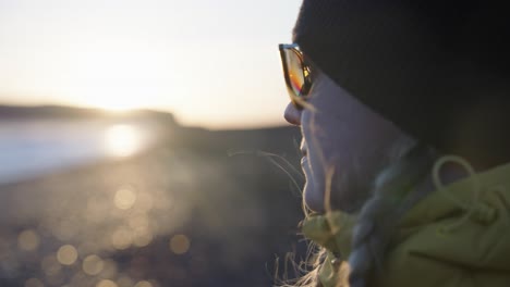 closeup on a face of the talent during a sunset at the black sand beach, iceland