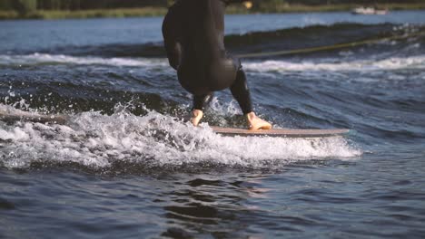 surfer surfing longboard in wave with cross step and touches wave