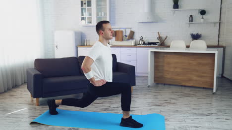 fit training at home. fit man exercising at home in living room