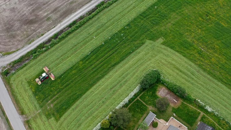 Tractor Mowing Grass In The Rural Fields In Daytime