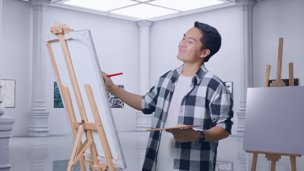 아시아 남성 예술가가가 갤러리에서 오일 페인트와 브러쉬로 캔버스 위의 마무리 그림을 축하하고 있습니다.