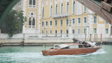 venice taxi boats passing under accademia bridge