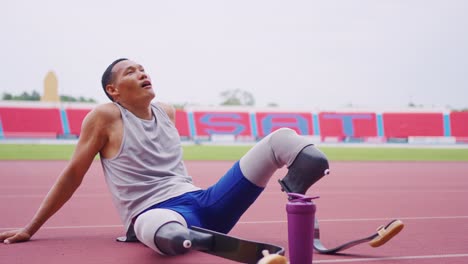 atleta con piernas protésicas descansando después de una carrera