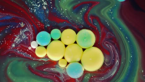 colorful bubbles. abstract yellow, red, blue, green mixture on a black background. artistic color paint background.