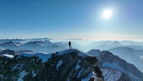 climber with ice axe standing on a snow-covered mountain