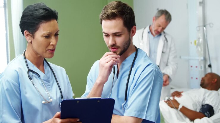 Two doctors discussing over digital tablet