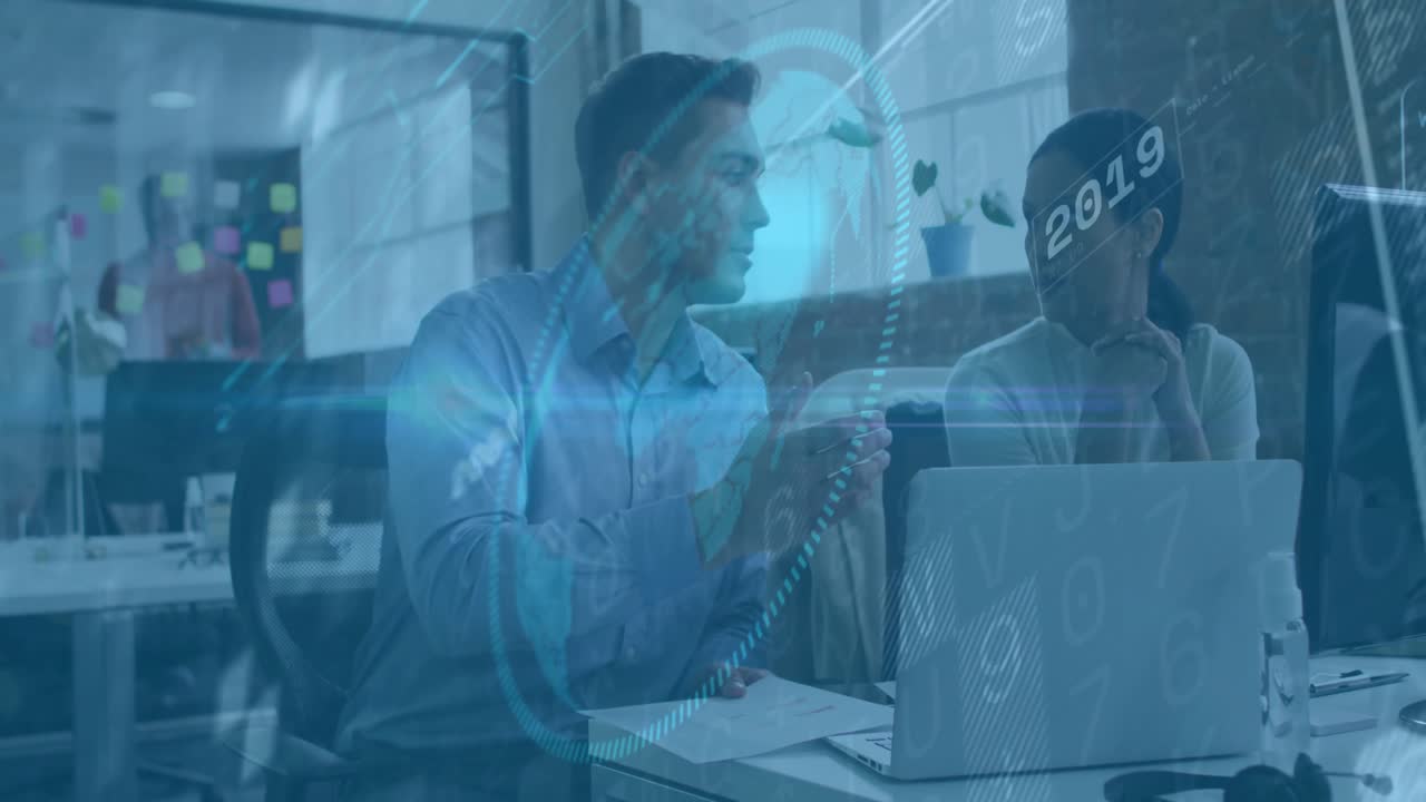 Business analyst initiating data overlay pointing to chart while colleague following trend progress
