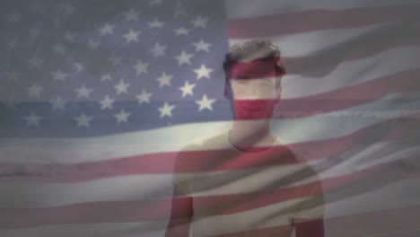 American-flag-waving-against-portrait-of-caucasian-man-standing-at-the-beach