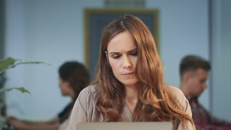 business woman typing on computer at coworking. professional getting good news.