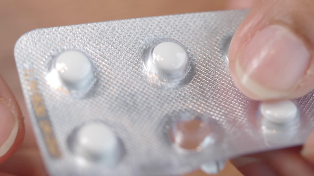 Taking pills from blister pack