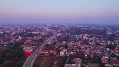 farming land with shri udasin sangat rishi ashram and independent houses at day time, moving up, circle shot, drone shot, 4k.