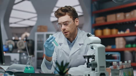 disappointed researcher looking microscope in medical laboratory close up.