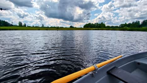 point of view of paddling a kayak on a slow flowing river during a hot afternoon. summer sports. rowing canoe