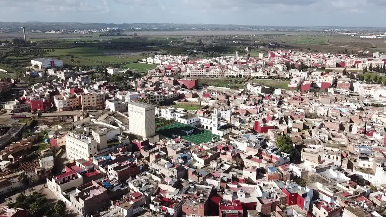 Một cảnh quay flycam góc cao ngoạn mục ghi lại toàn bộ cấu trúc đô thị của Larache. Nổi bật là Nhà thờ Hồi giáo Lớn, những khu phố truyền thống và những cánh đồng xanh bát ngát trải dài đến chân trời.
