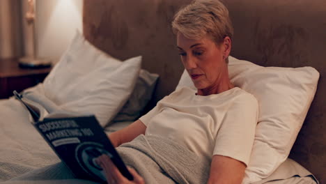 Senior-woman-in-bed,-reading-book