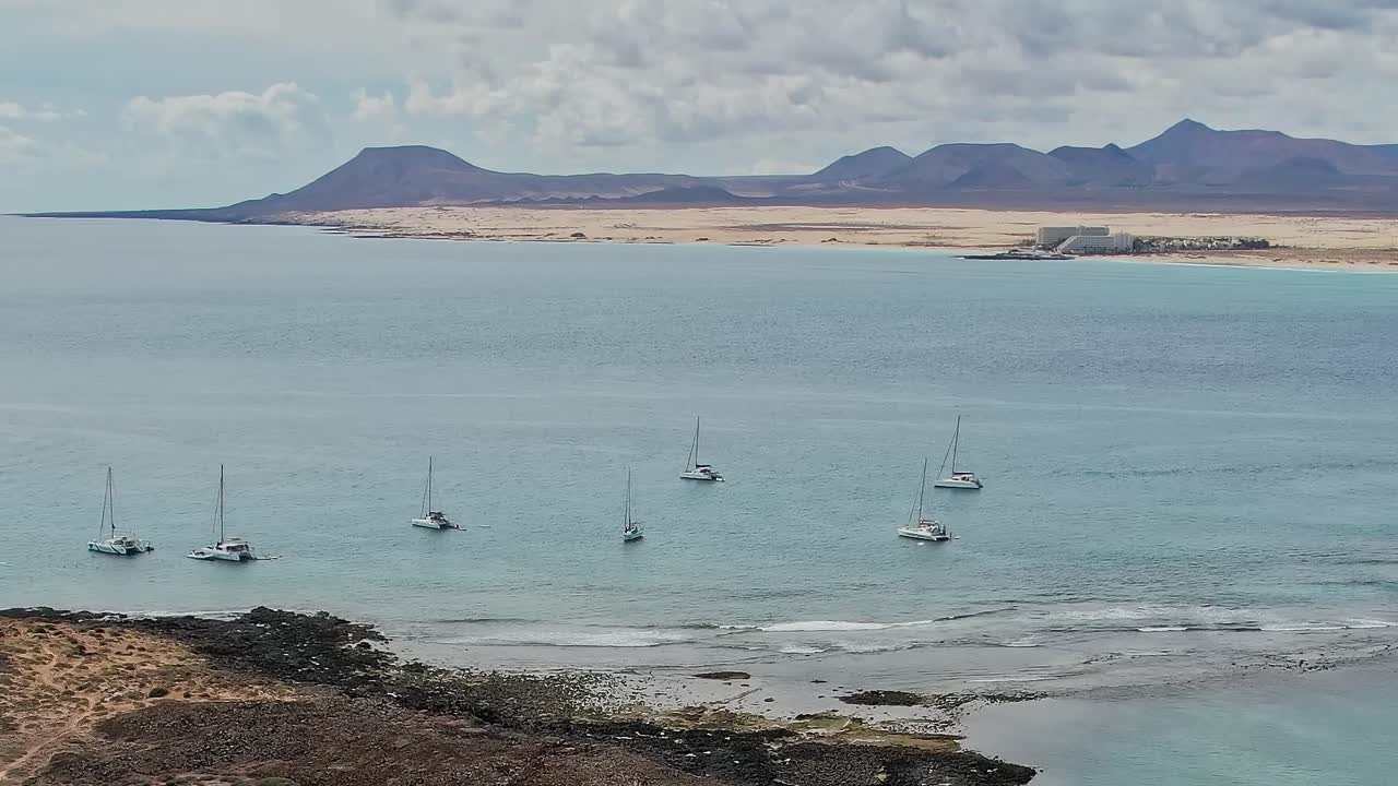 Boats anchored in calm water near Lanzarote in the Canary Islands