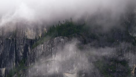 foggy atmosphere on the stawamus chief hike mountains in squamish british columbia, canada