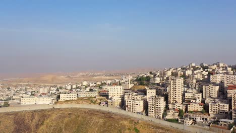 cityscape with a separation wall on a hill