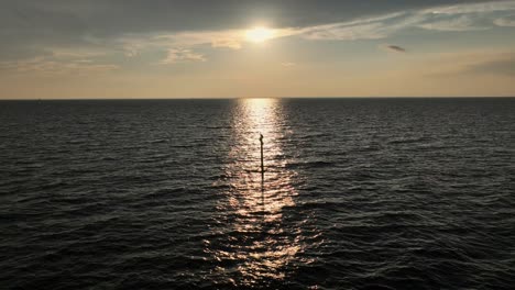 Sunsetting-in-Mobile-Bay-as-a-Pelican-watches-perched-on-a-pole