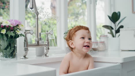 happy baby bathing funny toddler taking bath in kitchen sink having fun with soap bubbles 4k