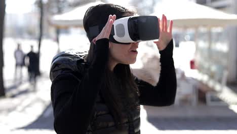 excited woman in vr headset on street