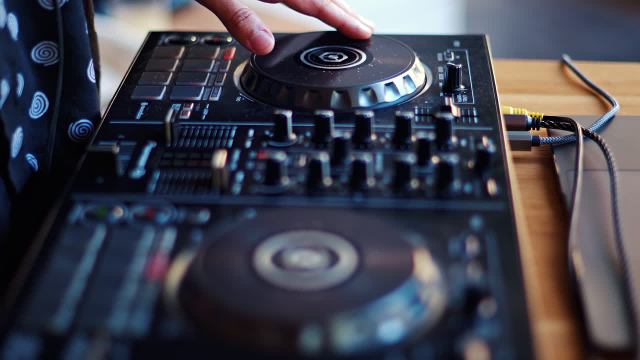 Close up of a woman touching the buttons of a DJ controller