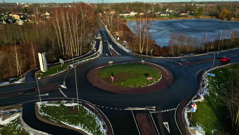 aerial big roundabout town infrastructure intersection in winter with light traffic in rural town