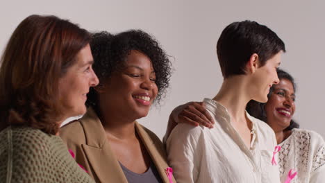 Close-Up-Studio-Portrait-Of-Smiling-Multi-Racial-Group-Of-Women-Of-Different-Ages-Wearing-Pink-Breast-Cancer-Awareness-Ribbons-2