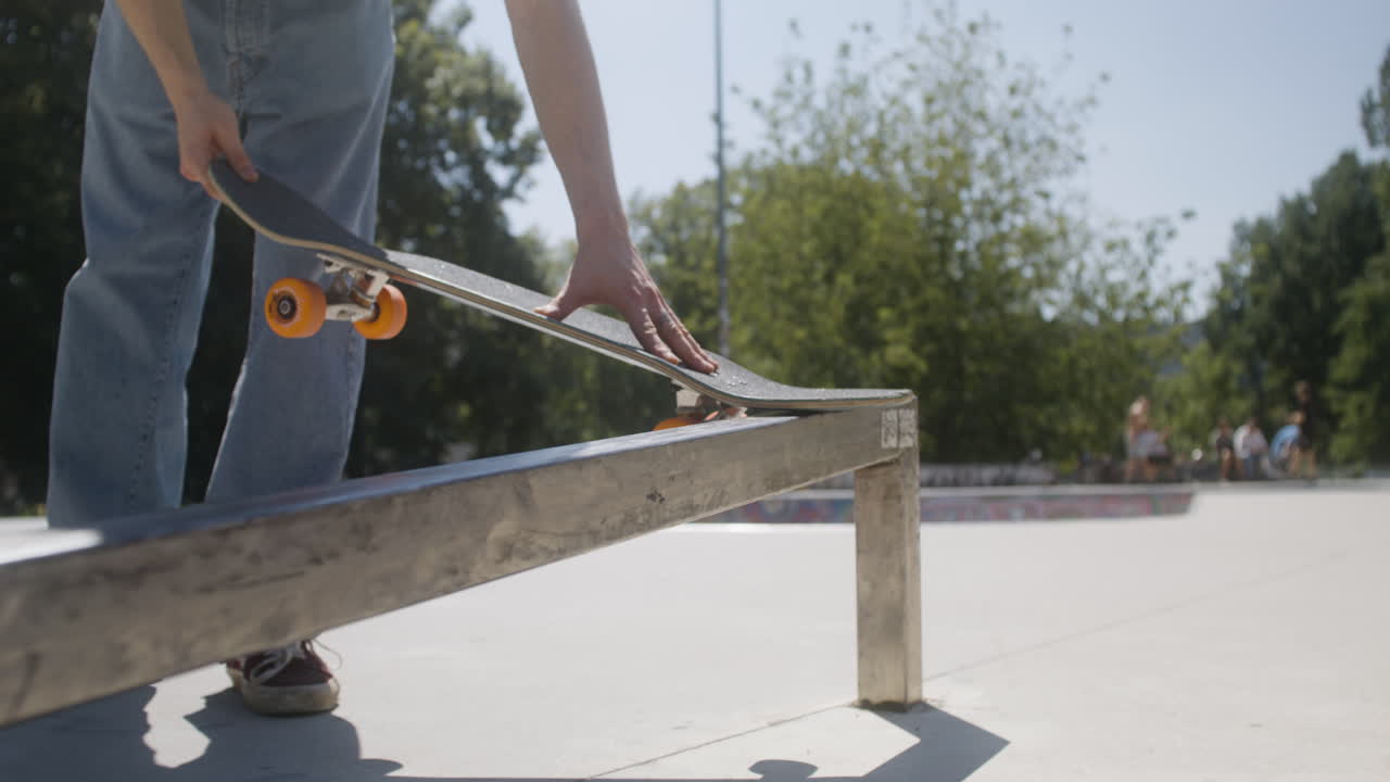 Boy explaining a trick to his friend in skatepark.