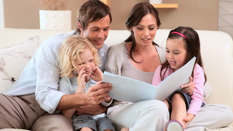 smiling family reading a book