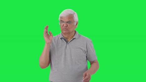 Disguised-Indian-old-man-smelling-something-bad-Green-screen