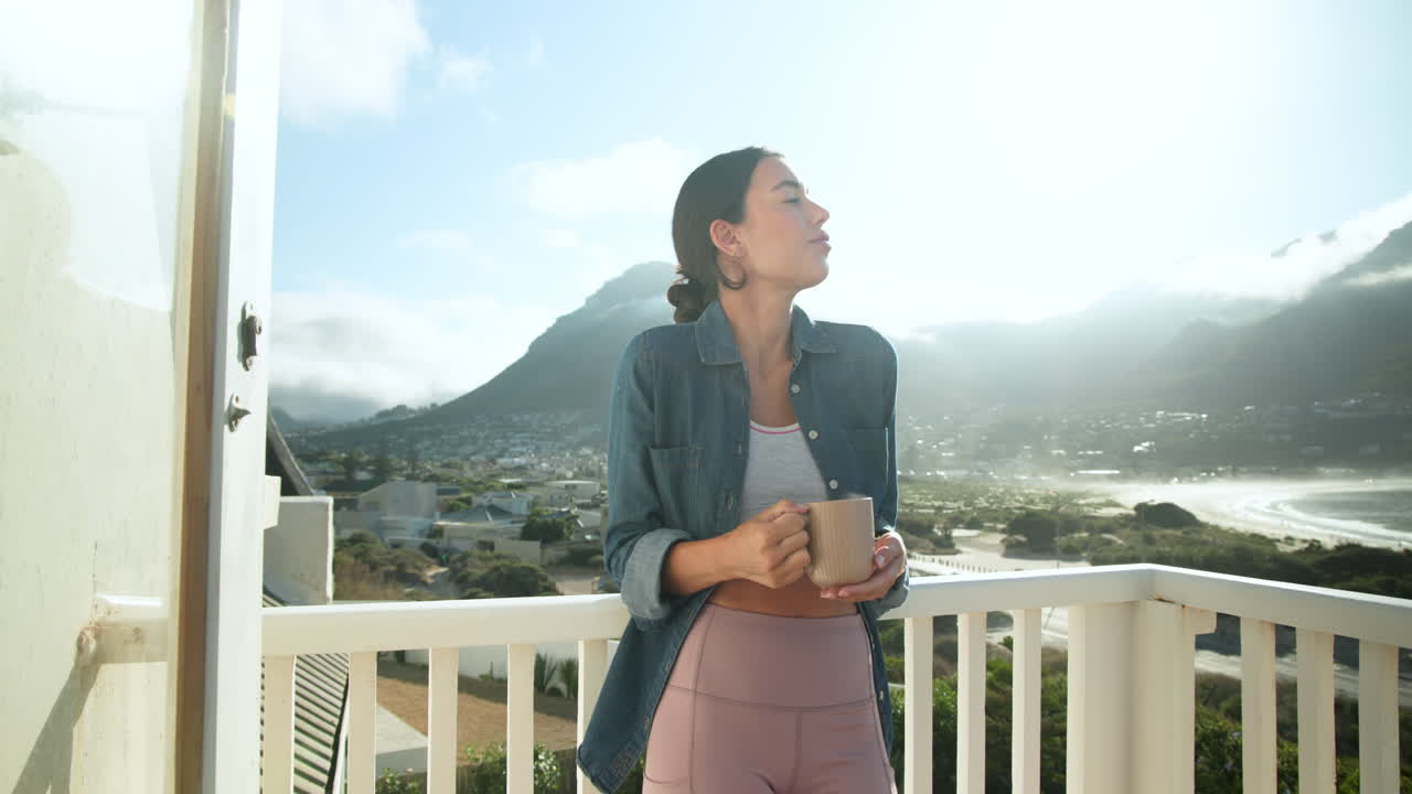 Woman enjoying morning coffee on balcony, embracing sunlight and mountain view, copy space