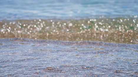 close up of water on the beach in slow motion