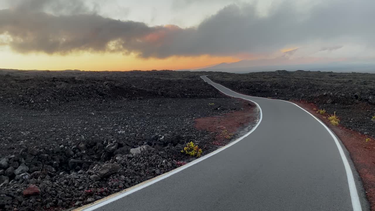 Minimalist Mauna Loa access road in lava fields after sunset