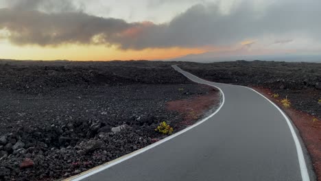 minimalist mauna loa access road in lava fields after sunset