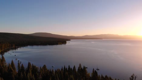 drone shot of a lake and forest trees surrounding the lake