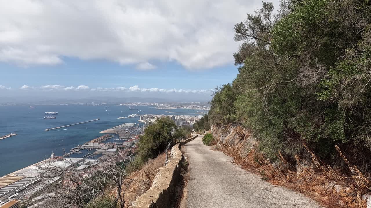 View over an old road leading down the rock of Gibraltar. Offering beautiful views on the Ocean and city skyline