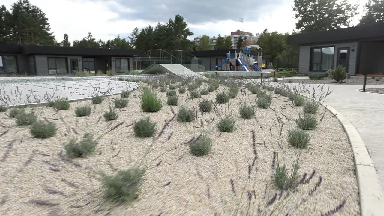 complejo residencial moderno con jardín de lavanda y patio de recreo