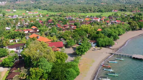 aerial-of-tropical-Lovina-beach-coastline-with-indonesian-jukung-boats-in-ocean-on-sunny-day-in-Bali-Indonesia