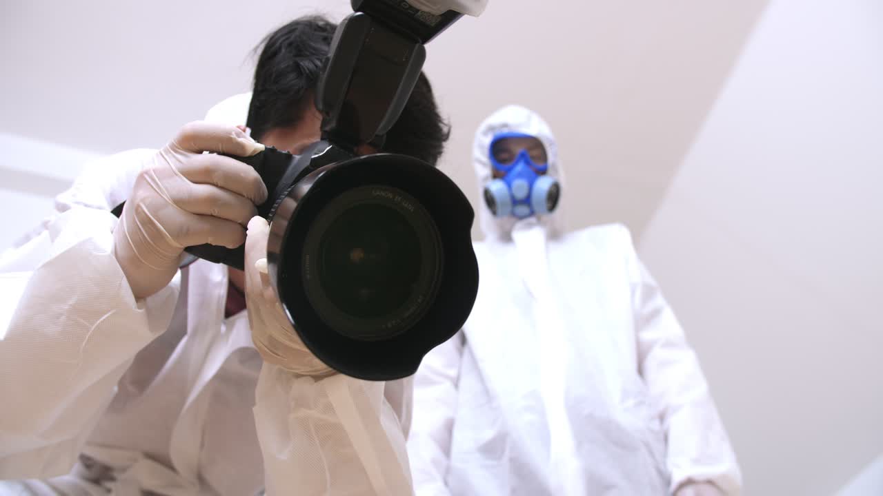 Forensics Experts Taking Pictures Of The Deceased