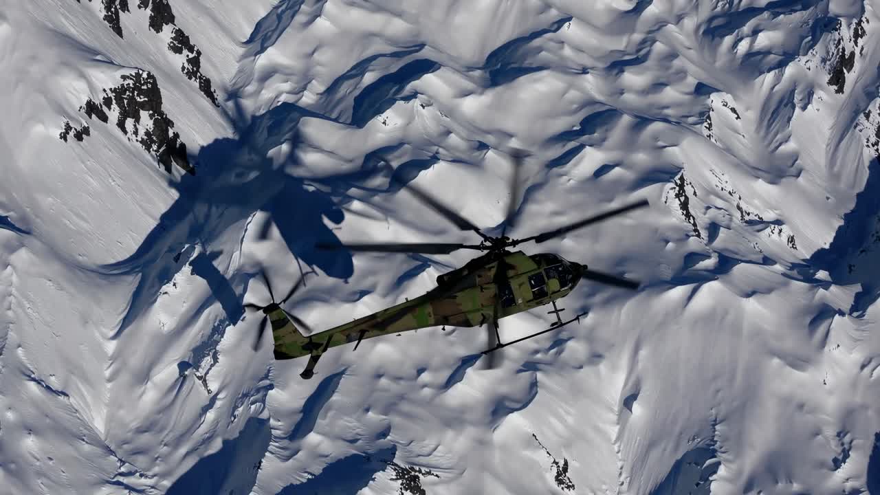 Aerial view of a helicopter flying over snowy mountains, capturing dynamic motion and shadow play