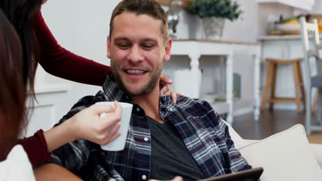 Happy-couple-using-digital-tablet-while-having-coffee-4k