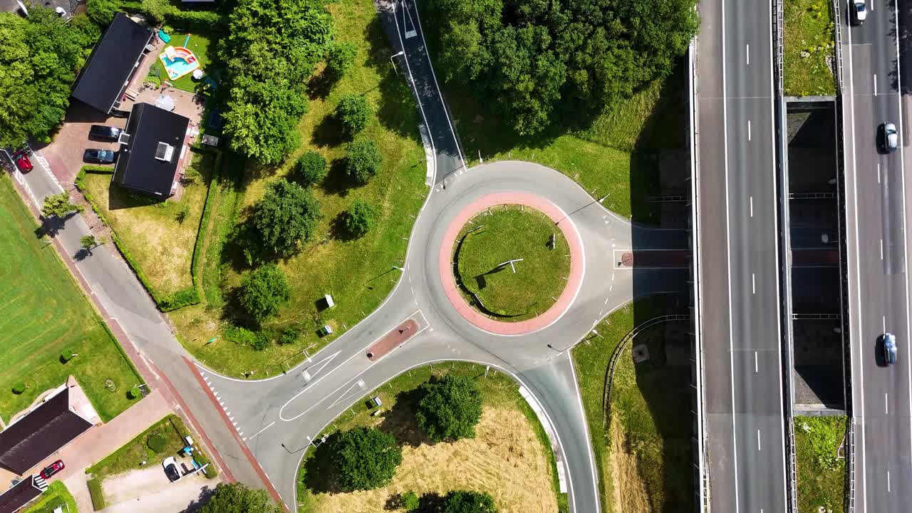 Aerial View of Roundabout with Highway Overpass