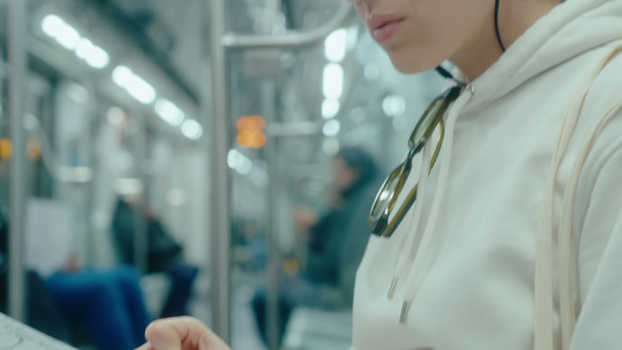 Woman in Earphones Drawing Sketch during Metro Ride