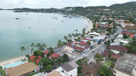 Aerial-view-revealing-blue-ocean-water-and-white-sand-beach-in-Thailand