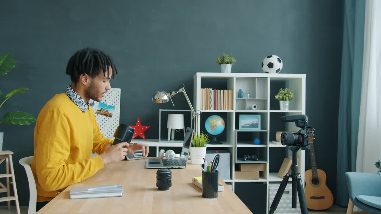 Man reviews camera equipment in a home office setting
