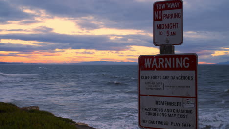 Timelapse-of-Danger-Sign-Near-Ocean-During-Evening