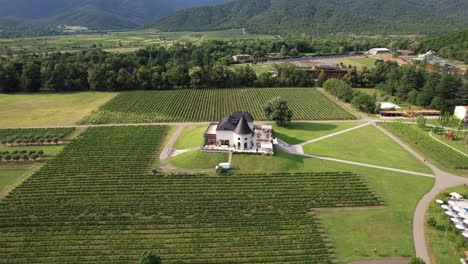 Drone-footage-of-Chateau-Buera-Winery-and-Vineyards-amid-the-lush-green-mountains-near-Lopota-Lake-in-Kakheti,-Georgia