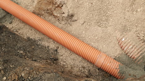 orange pvc pipes during installing sewage line in a village at leiria, portugal